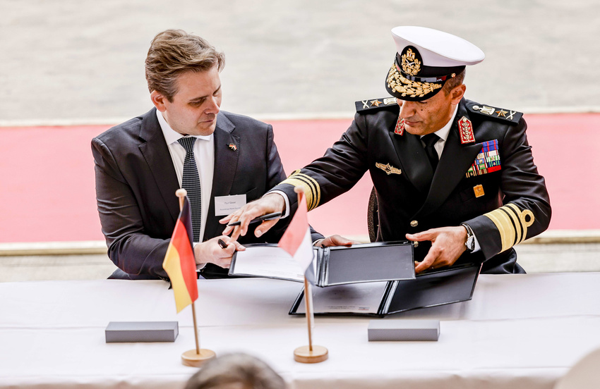 CFO Paul Glaser and Vice Admiral Atwa signing the handover documents